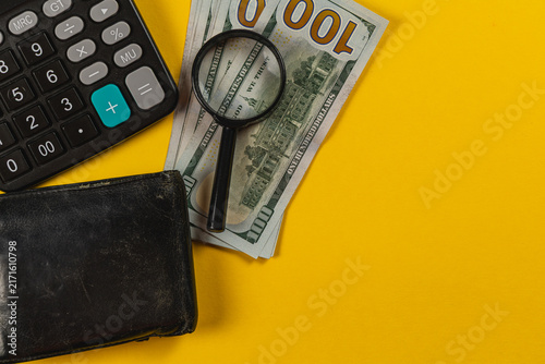 Konstfotografi Budgeting tools on a yellow surface with cash and calculator