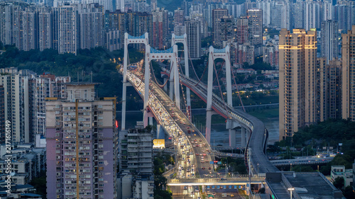 Bild auf Leinwand Chongqing Bridge at Dusk with Illuminated Traffic and Urban Skyline