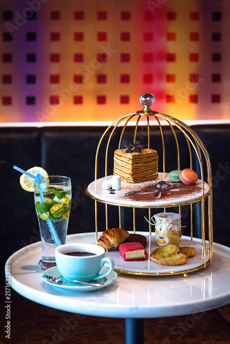 Elegant Afternoon Tea Set with Desserts, Coffee and Citrus Mint Drink