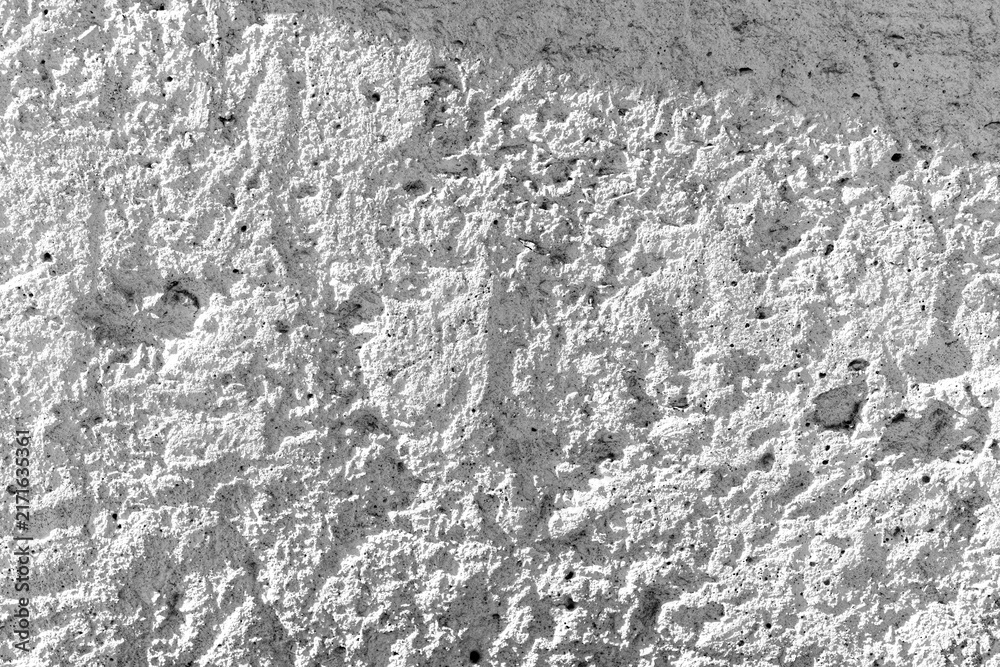 Naklejka premium Rough concrete background with shadow casting on its textured exterior