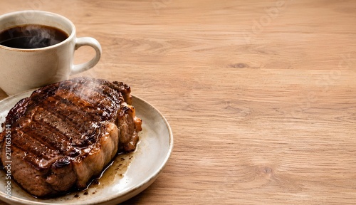 Grilled steak and hot coffee with copy space for restaurant menu advertising.