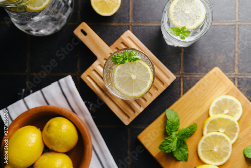 Картината върху платно Fresh lemonade with lemons and mint leaves on a table