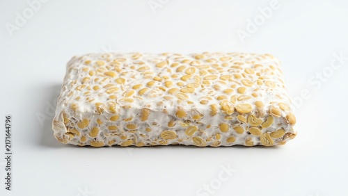 Raw organic tempeh block isolated on white background
