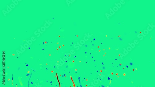 Colorful confetti and paper streamers burst upwards against a bright green screen background for festive celebrations.
