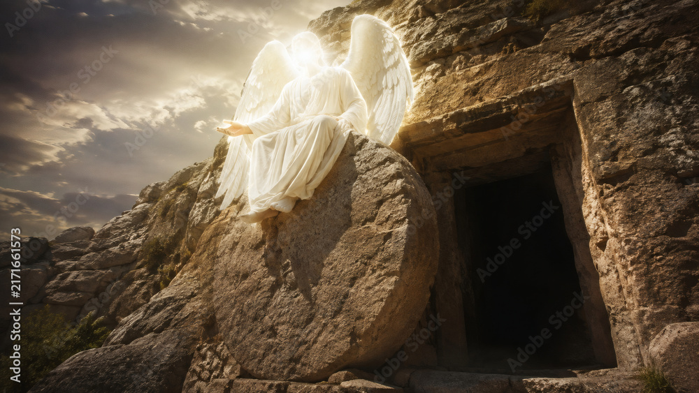 Fototapeta premium Glowing Angel With White Wings Sitting Beside The Empty Tomb Of Jesus