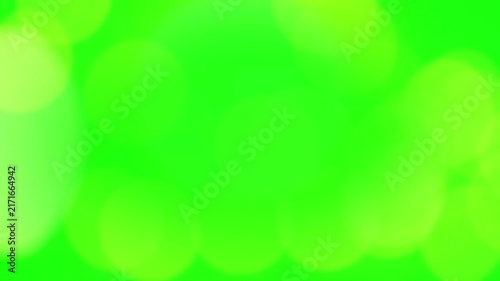 Bokeh light circles overlay a bright green background to create a soft, vibrant abstract graphic design.