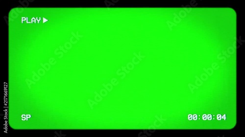 Camcorder screen overlay display features play status and timecode over a green screen chroma key background.