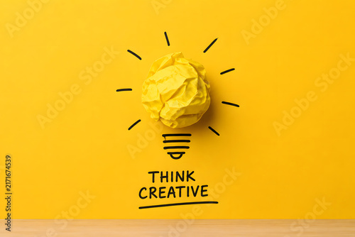 A crumpled yellow paper ball shaped like an idea appears as a glowing light bulb, representing creativity, innovation, and problem solving.