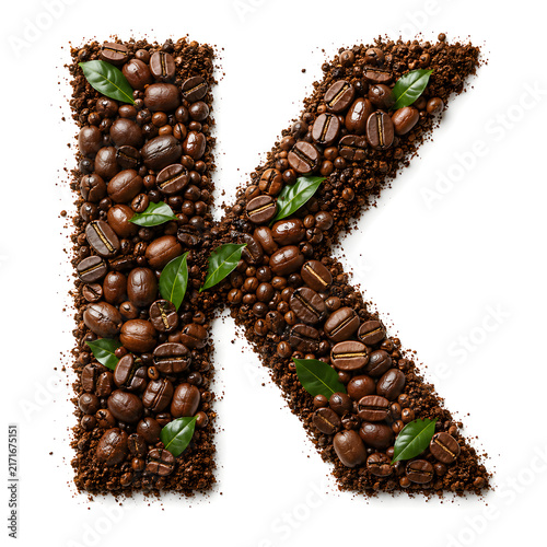 Creative alphabet letter A formed from roasted coffee beans, grounds, and green leaves on a clean white background.