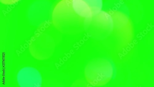 Soft glowing bokeh circles float across an empty green screen backdrop designed for colorful lighting overlays.