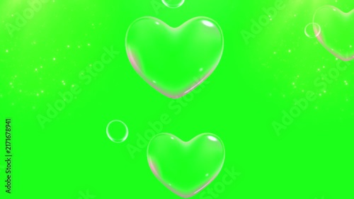 Heart shaped soap bubbles float gracefully against a solid green screen chroma key background for romantic overlays.