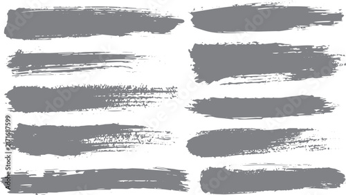 Minimal black ink brush strokes with grunge paint texture dry brush marks and monochrome artistic design on white background