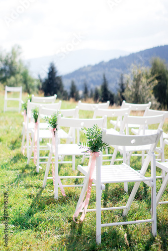 Fotografie Outdoor wedding ceremony setup with white chairs