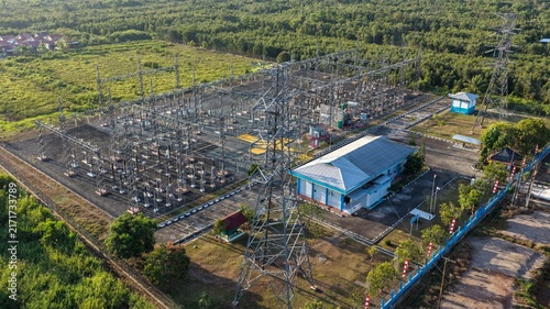 Aerial view of an electrical power substation surrounded by trees and vegetation in Indonesia