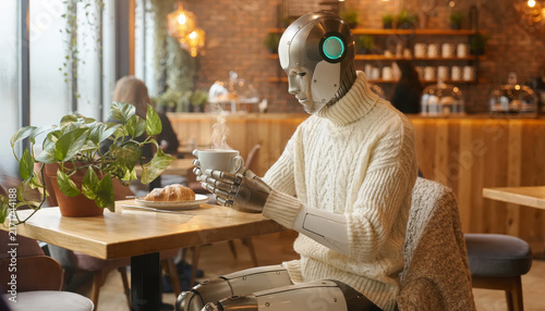 Humanoid robot with a human-like face sitting in a cafe.