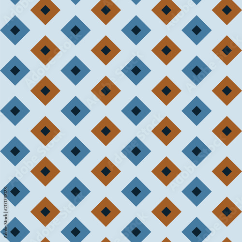 Seamless pattern created from small navy blue diamonds in larger blue and brown diamonds on a pale blue background