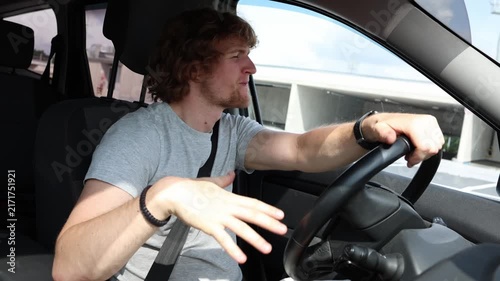 Distracted driver dances and entertains himself behind the wheel showing poor attention careless behavior and unsafe driving habits while moving through busy city traffic