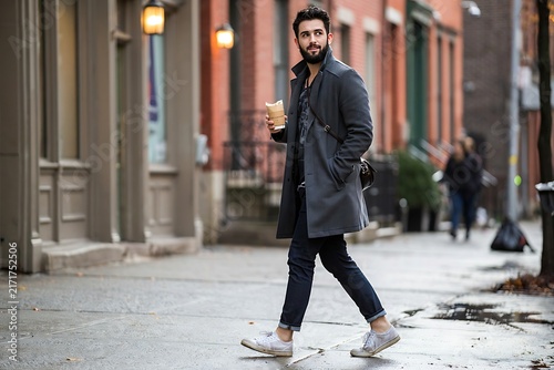 Handsome Bearded Man Walking with Coffee Cup along Urban Town Sidewalk