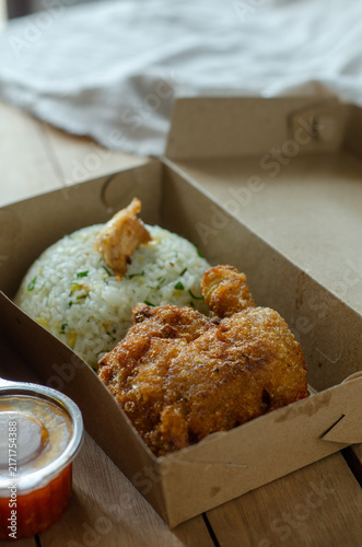 Konstfotografi Crispy Fried Chicken with Seasoned Rice in Takeaway Box