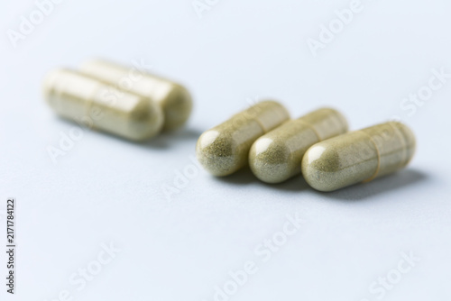 Barley grass capsules. Antioxidants. Concept for a healthy dietary supplemen capsules. Antioxidants. Concept for a healthy dietary supplementation. Bright background. Soft focus. Close up. Copy space.