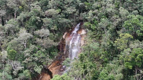 Aerial Drone Orbit Around a Remote Untouched Waterfall Deep in the Mountain Forest of Khanh Le Pass, Lam Dong, Vietnam, Surrounded by Lush Tropical Vegetation and Rugged High Terrain