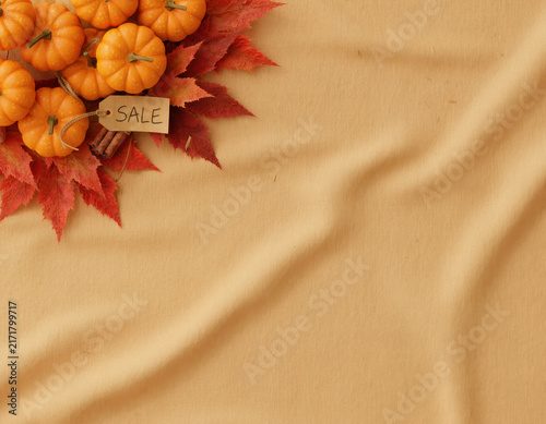 Autumn harvest display with orange pumpkins, red maple leaves, and a rustic sale tag on textured beige fabric perfect for seasonal promotions