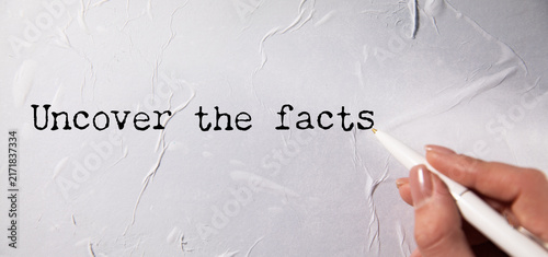 Photography uncover the facts text on paper