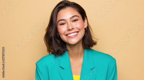 Smiling Panamanian businesswoman in green jacket on beige background with copy space