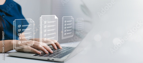 Canvastavla Digital document checklist concept showing a professional using a laptop with multiple virtual forms and checkmarks, representing task management, compliance, verification, productivity, and workflow