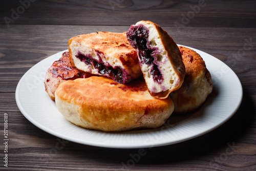 Fried blueberry pies on plate