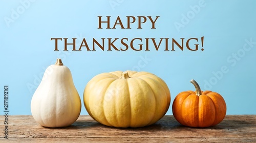 Happy thanksgiving greeting card with colorful pumpkins and gourds on wooden table