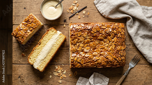 Traditional German Bee Sting Cake Bienenstich with Almond Crust and Cream Filling on Wooden Table