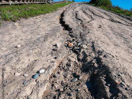 Cuadro en lienzo Deep ruts and soil erosion caused by heavy rain on a gravel fitness trail hill