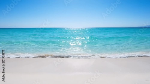 A serene beach scene with crystal clear turquoise water gently lapping onto a pristine white sandy shore, under a bright blue sky