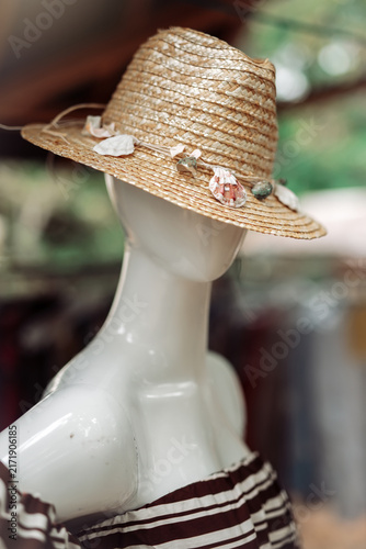 Konstfotografi Summer straw hat with seashells on a mannequin puppet