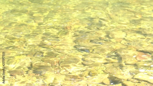 River water ripples making an abstract texture of water in motion, background