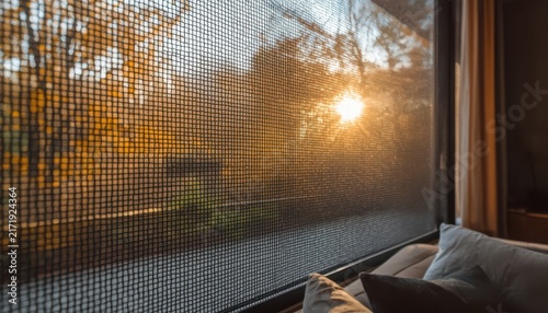 Window screen mesh with sunset view in living room interior