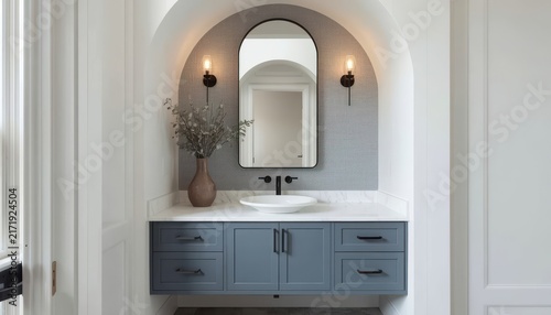Modern blue vanity with vessel sink and arched tiled mirror alcove