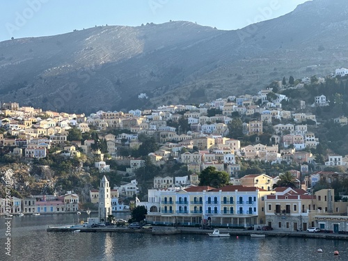 Colourful houses on hillside overlooking harbour in Symi, South Aegean, Greece, November 2025