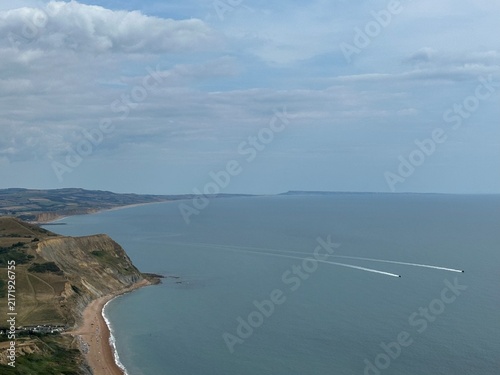 Jurassic Coast landscape with boats on the Atlantic Ocean seen from Golden Cap, Dorset, England, United Kingdom, July 2025