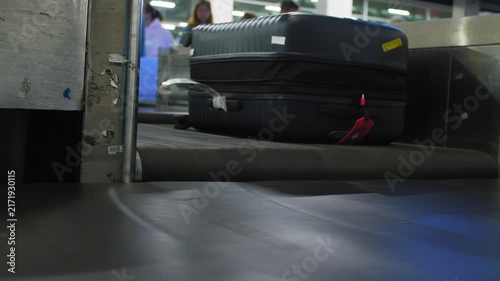 Close up of suitcases being moved by a baggage conveyor at an airport, 4k