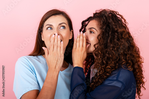 Fotografía Women sharing secret, whispering gossip, feeling surprised