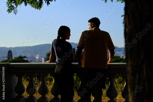 Fotografie rear view of Diverse young couple enjoying city view from barcelona viewpoint