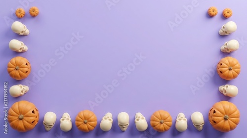 Halloween pumpkins and skulls arranged in a frame on a lilac purple background
