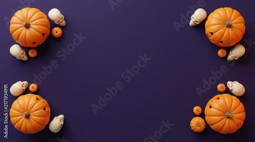 Halloween pumpkins and skulls arrangement on a dark purple background with copy space