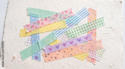 Colorful scrapbook tape strips with floral, heart, star, and checkered textured paper create cheerful and creative