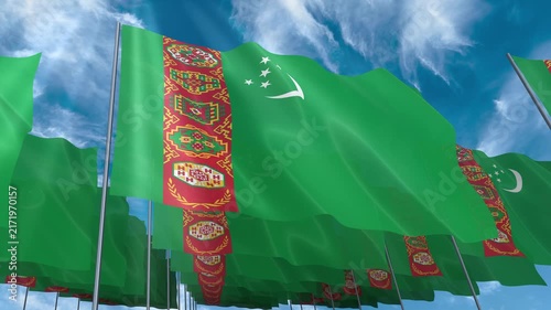 Multiple Turkmenistan flags seamless looping waving on blue sky