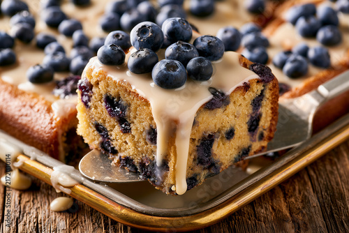 Blueberry Cake Slice Lifted From Baking Pan