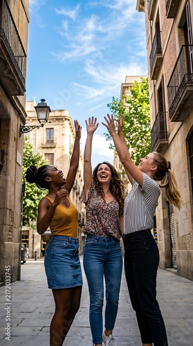 Three young women celebrating in city street