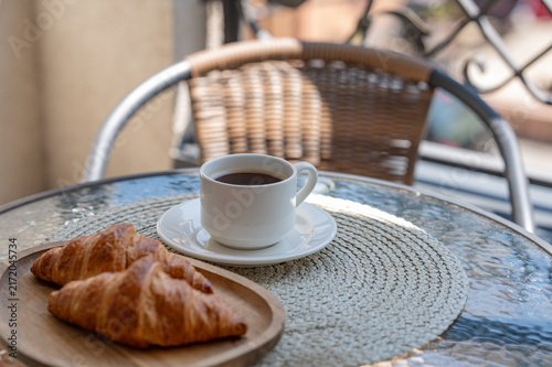 Coffee and Fresh Croissants on a Sunny Outdoor Cafe Table
